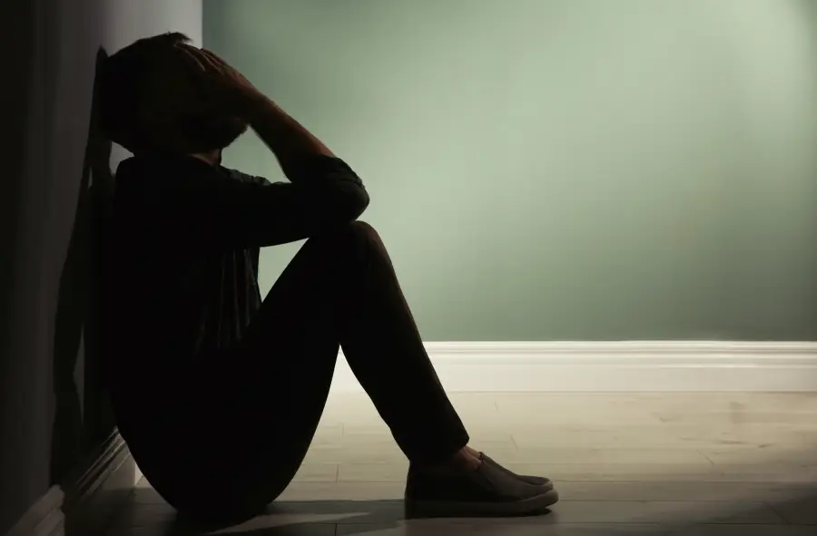Anhedonia – sad woman sitting alone, emotional numbness